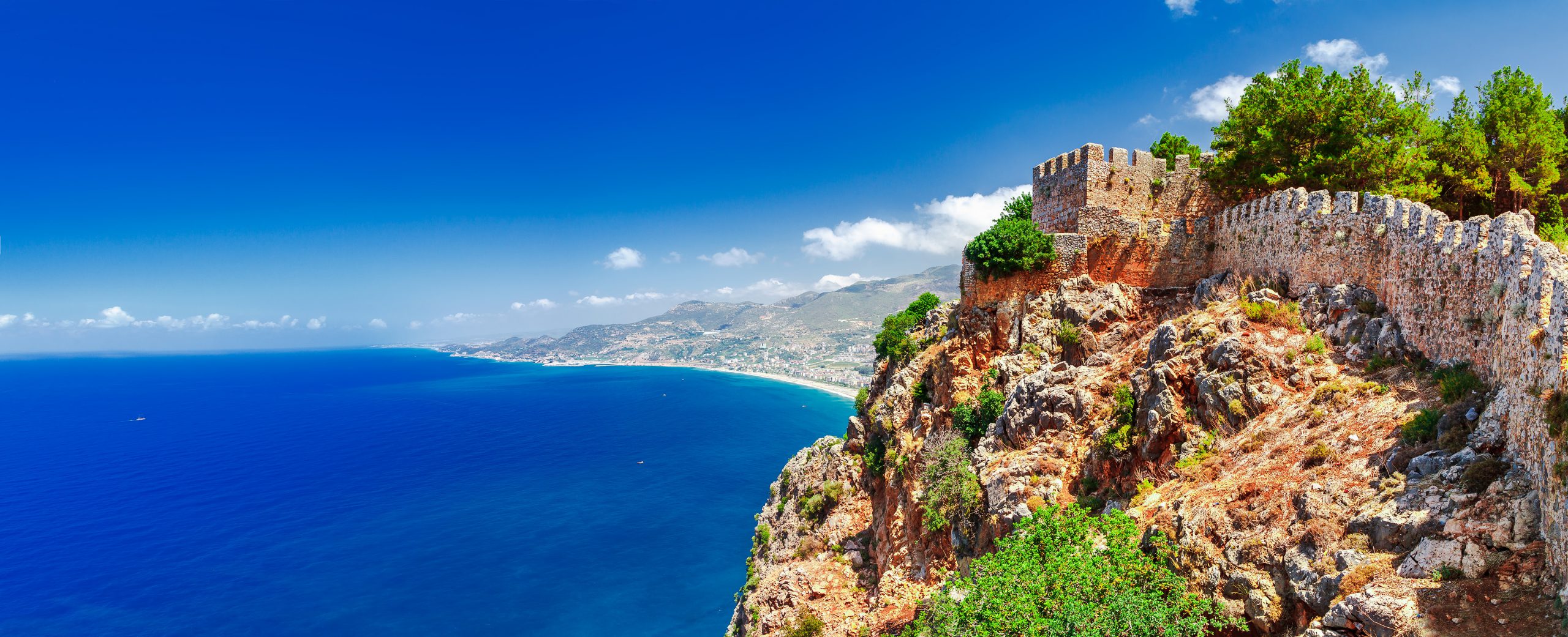 Beautiful sea panorama landscape of Alanya Castle in Antalya district, Turkey, Asia. Famous tourist destination with high mountains. Summer bright day and sea shore