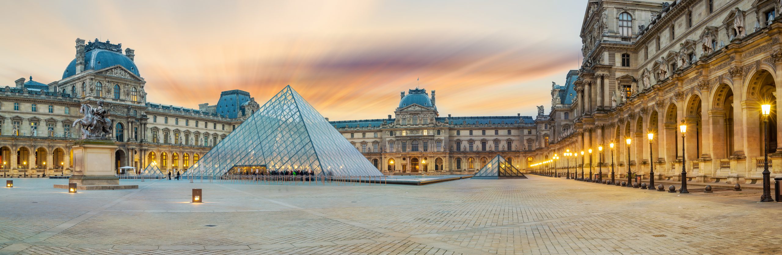 iew of famous Louvre Museum with Louvre Pyramid at evening