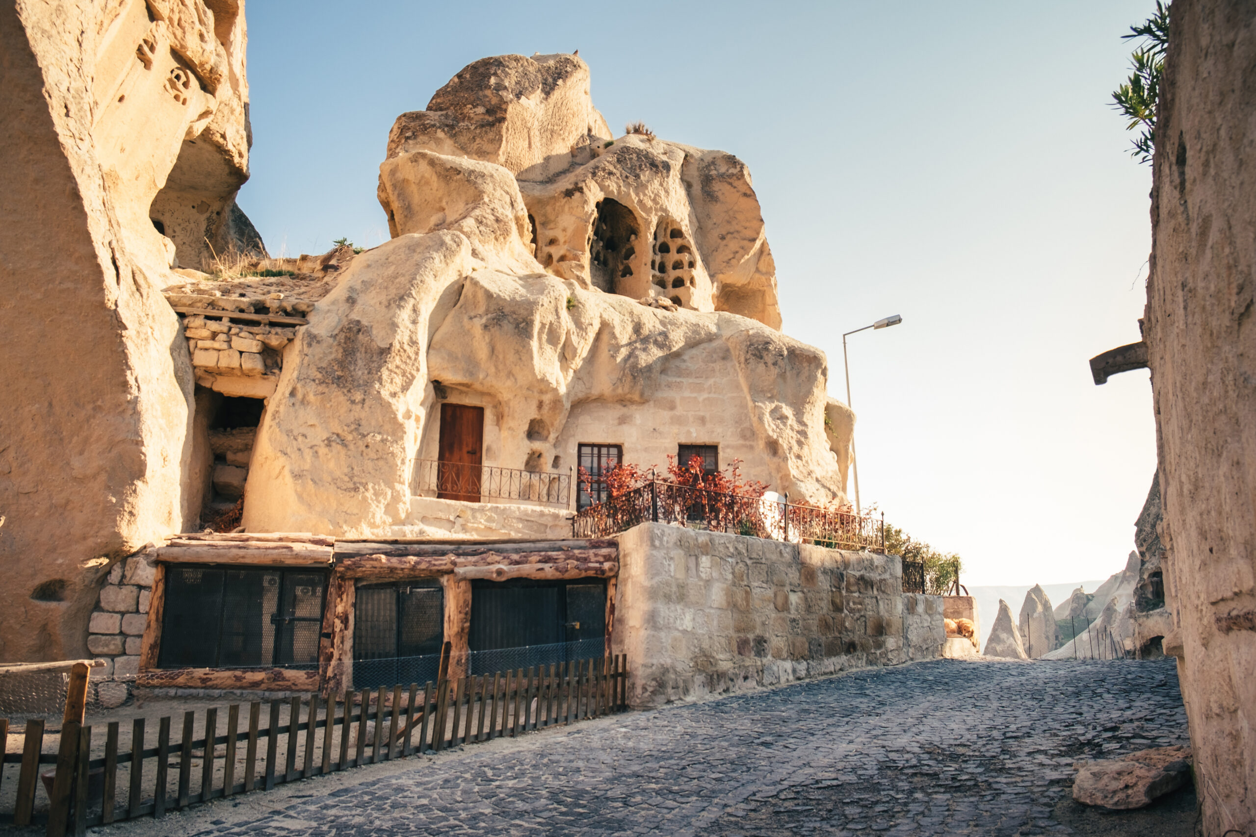 Narrow street of turkish village Goreme with cave houses in Cappadocia region, Turkey.