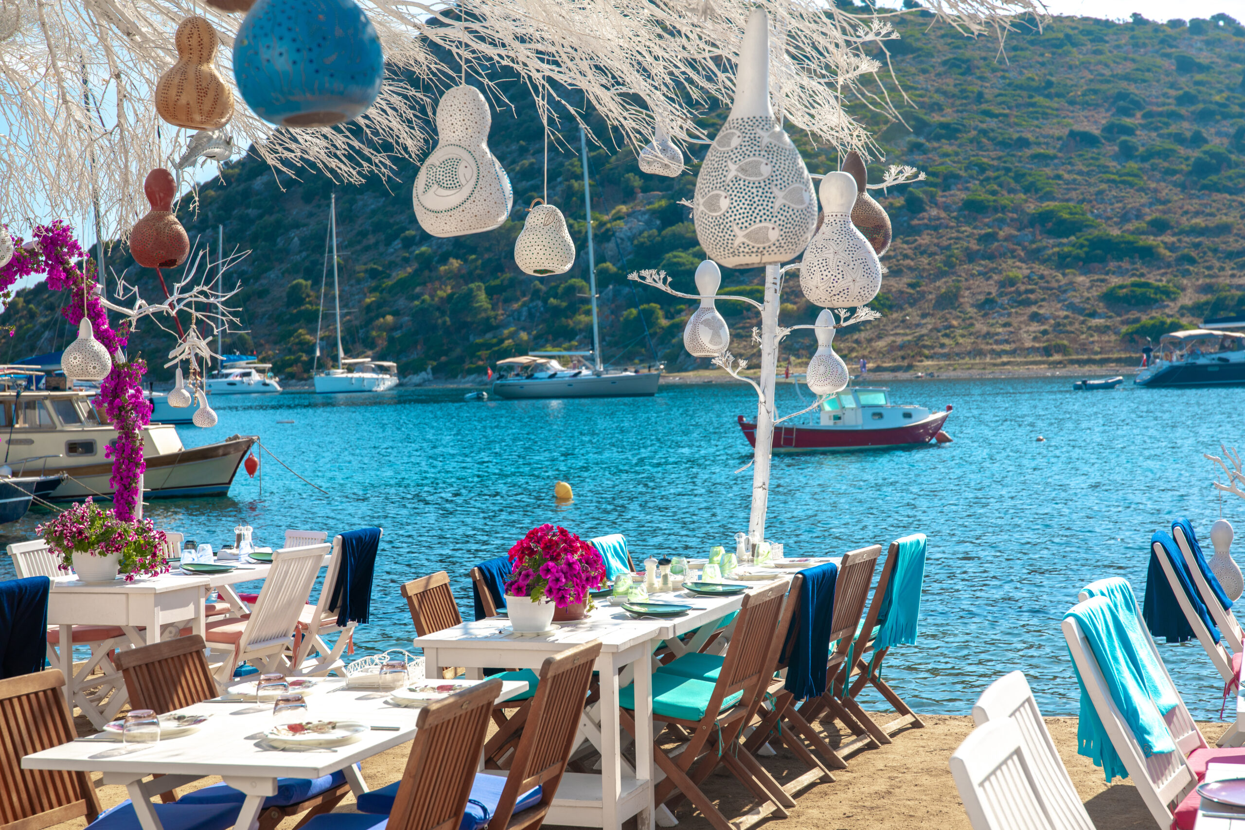 View of restaurant or cafe and bougainvillea flowers on beach in